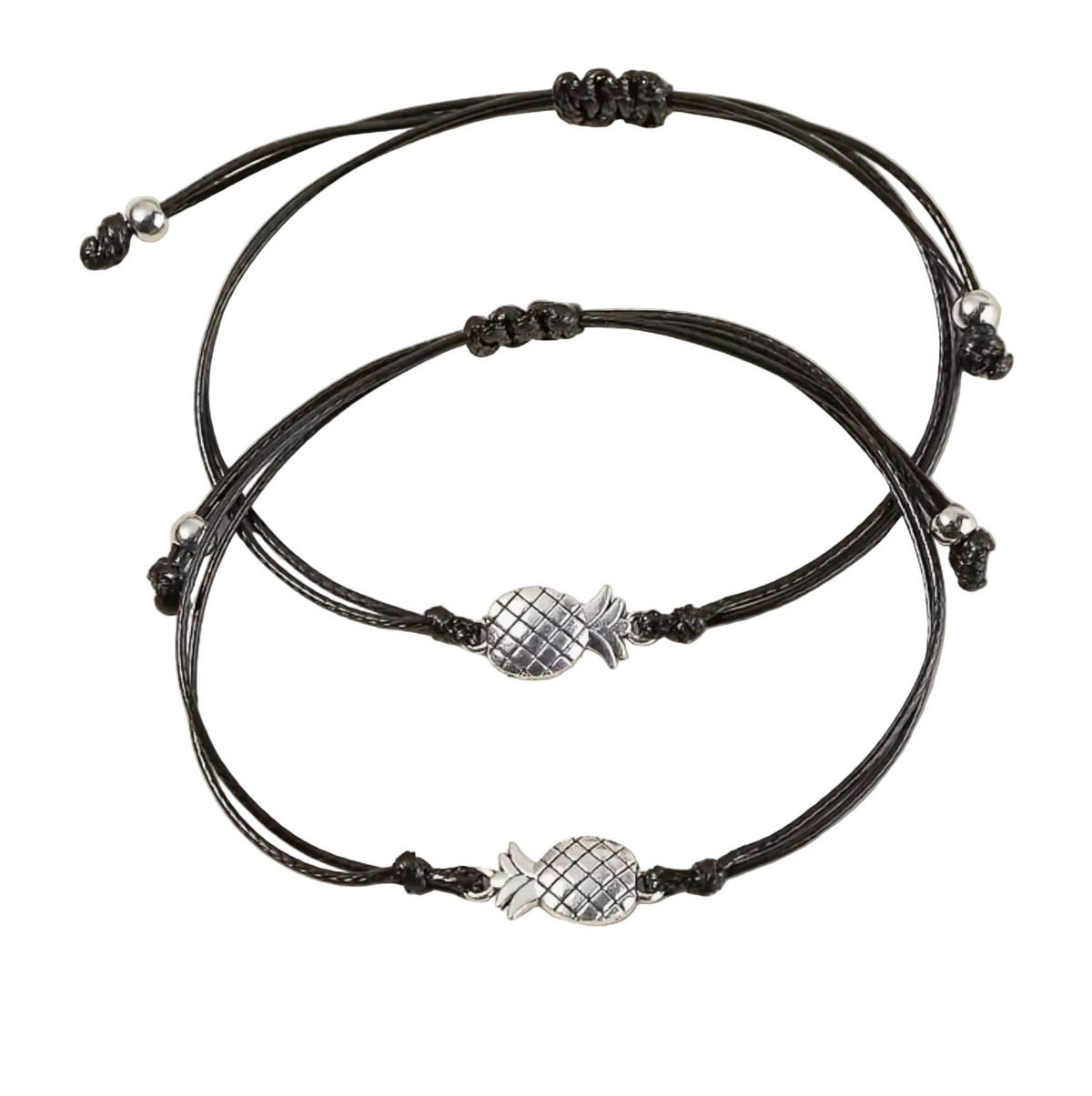 Two black cord bracelets with silver pineapple charms on a beige background